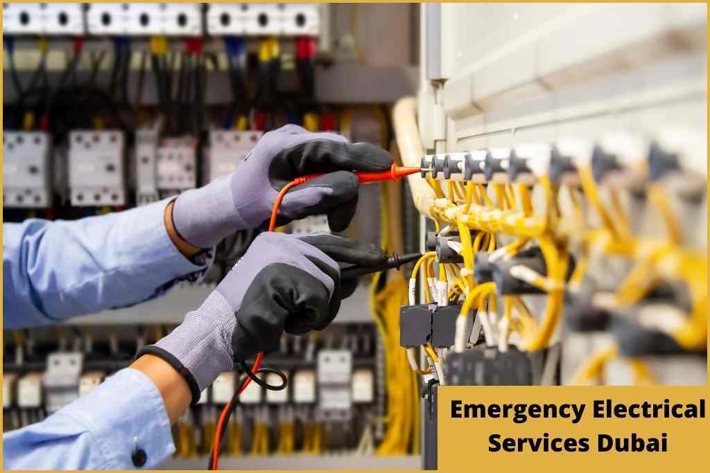 an electrician analysing and checking a current board full of wires