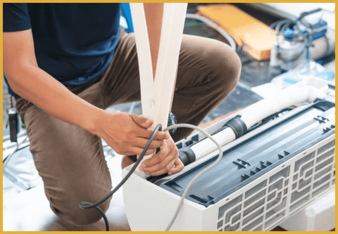 a technician repairing an ac