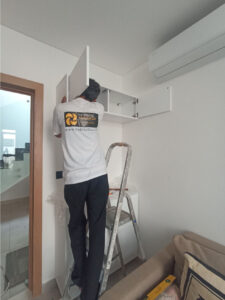 habitatlux handyman technician working to repair shelve