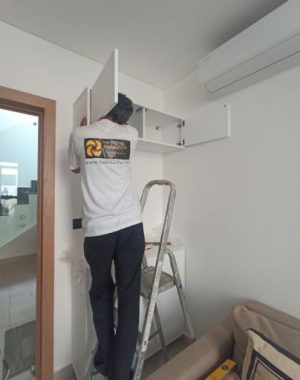 habitatlux carpenter dubai worker is in a stool repairing a wooden furniture