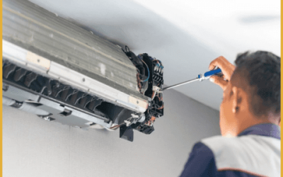 a technician opening an ac board with a screw on a wall