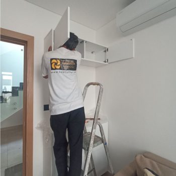 habitatlux handyman technician working to repair shelve